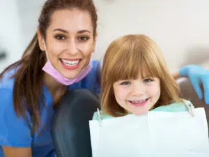Orthodontist with a young patient during an exam focused on children’s bite development