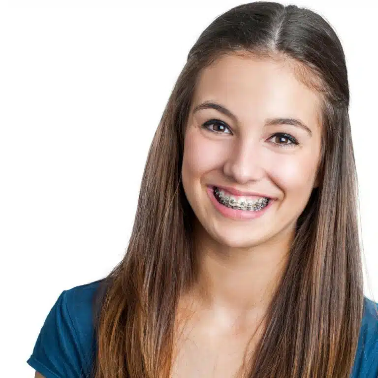 Child orthodontic patient smiling confidently with braces at school