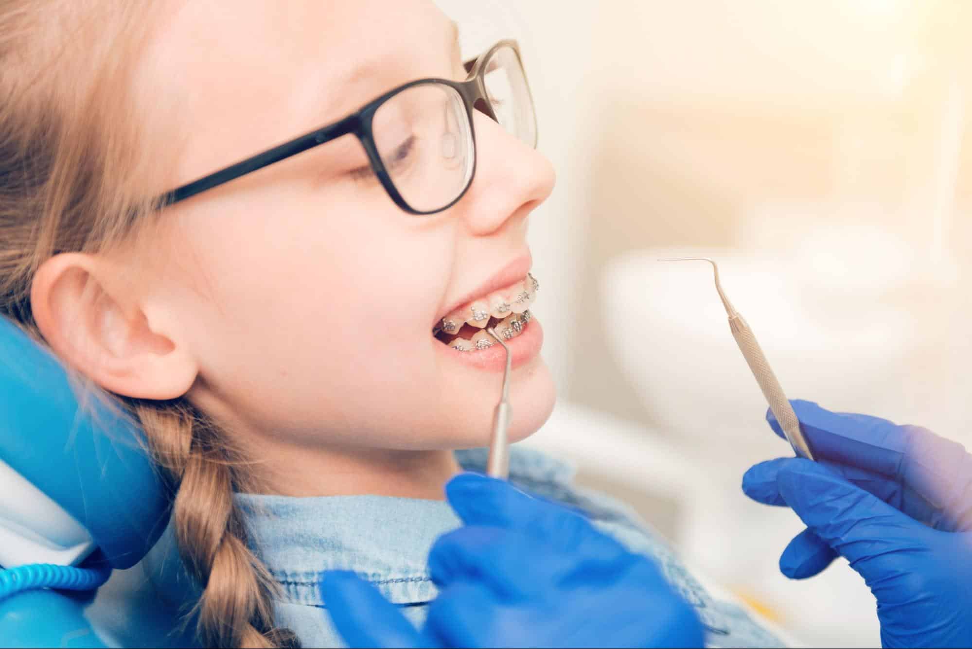 Teen orthodontic patient consulting with orthodontist to discuss braces treatment options