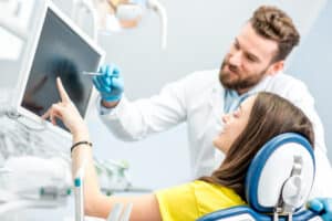 Orthodontist reviewing Invisalign refinement plan on screen